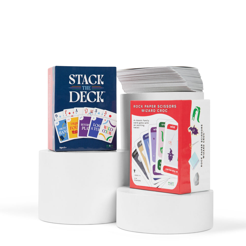Card game packaging with 'Stack the Deck' and 'Rock Paper Scissors Wizard Croc' on a white background